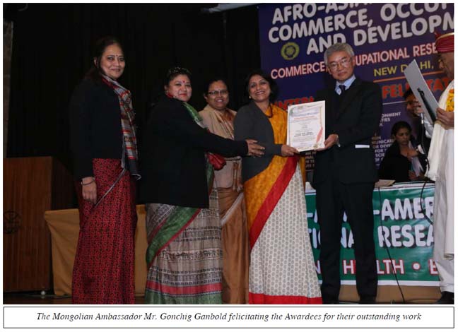 The Mongolian Ambassador Mr. Gonchig Ganbold felicitating the Awardees for their outstanding work